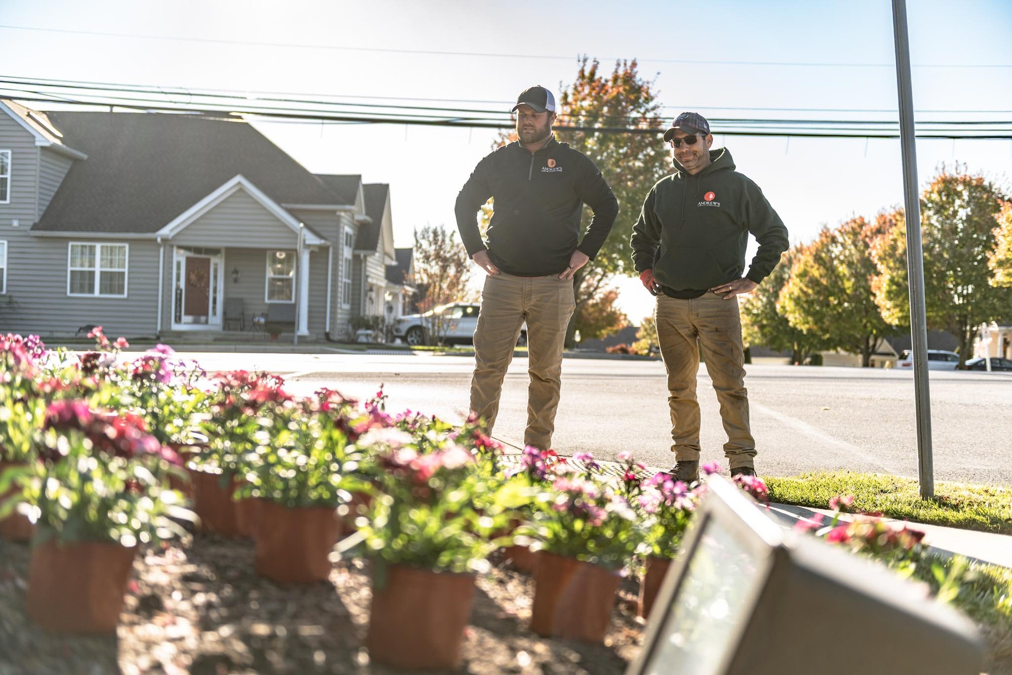 Andrews Lawn & Landscaping Account Managers reviewing plant bed